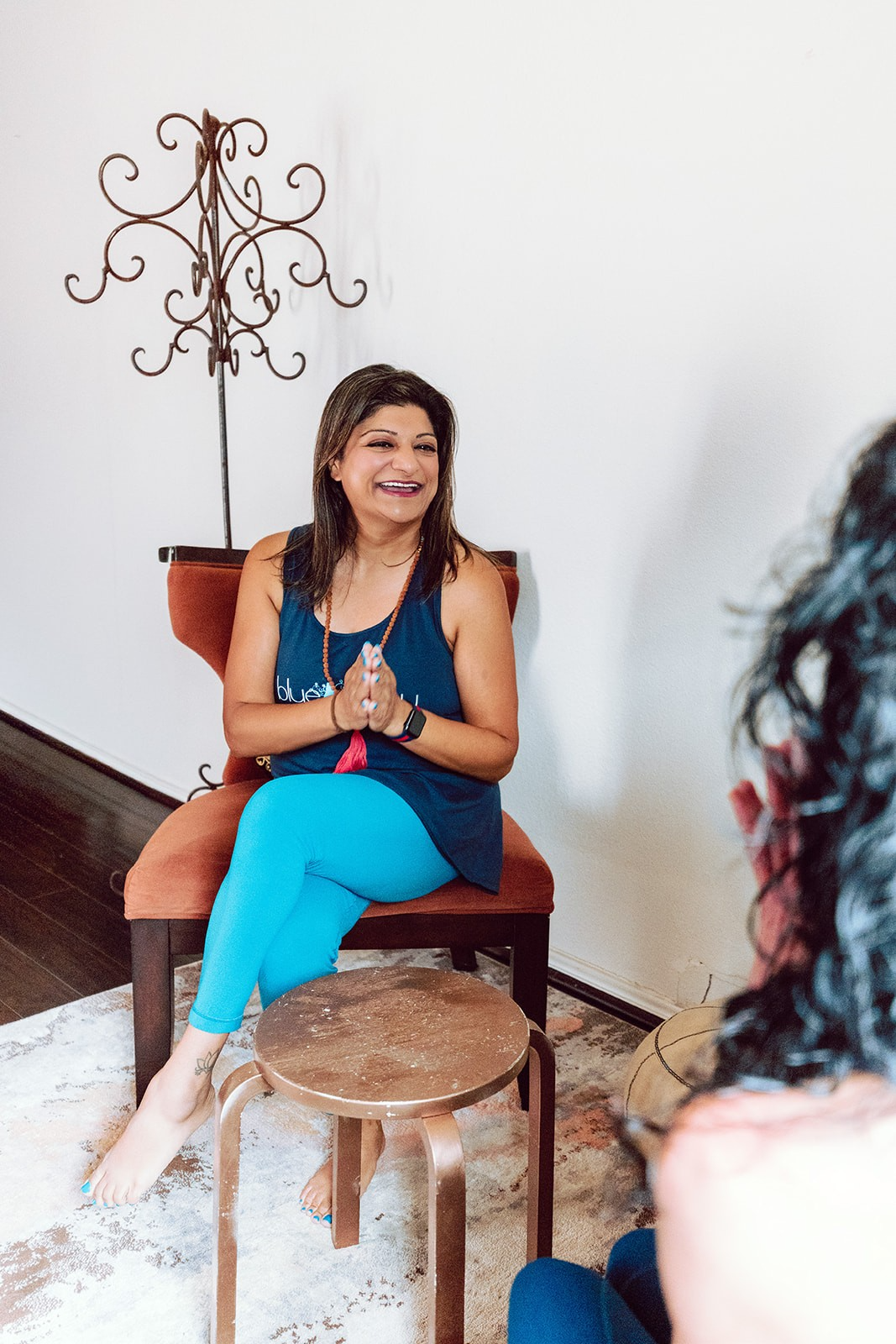 Noshin smiling and talking with students during a seated session