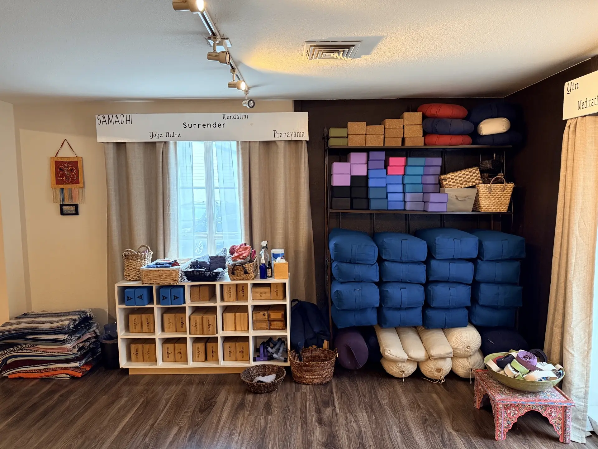 Prop room with bolsters, blocks and blankets beneath the Surrender sign
