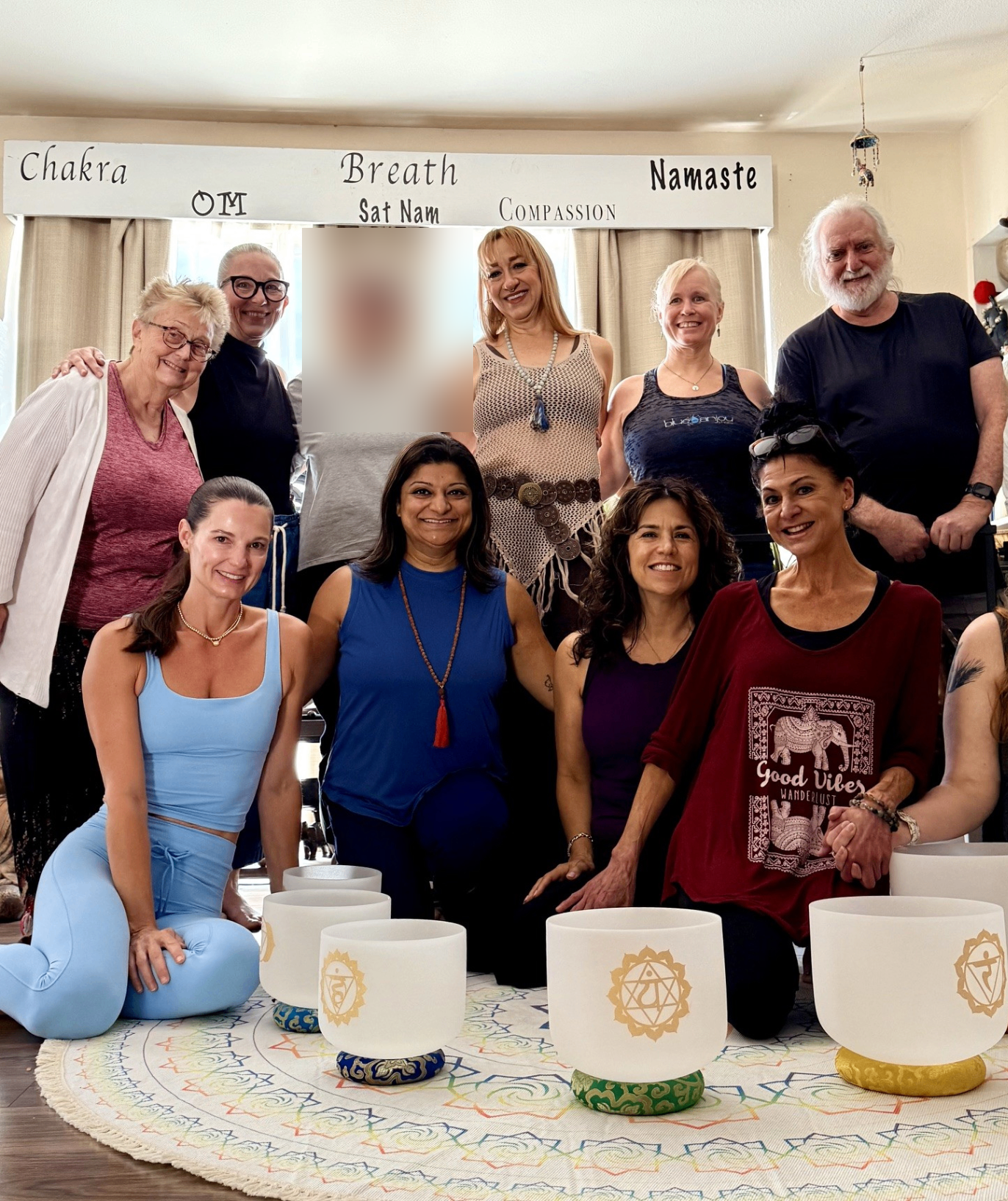 Blue Anjou yoga community gathered in namaste after class
