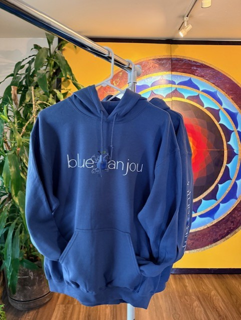 Navy Blue Anjou hoodie hanging in the studio