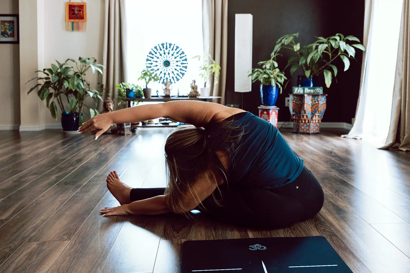 Student in a deep side stretch in the studio